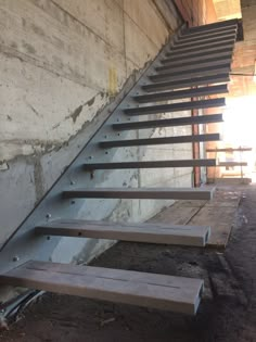 there is a set of metal stairs going up the side of a building with no people on it