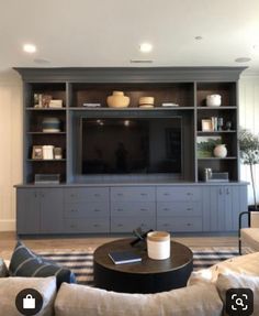 a living room filled with furniture and a flat screen tv on top of a wooden entertainment center