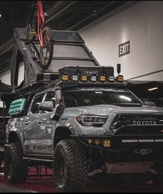 the truck is being displayed at an event with its lift on it's flatbed