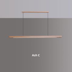 an overhead light fixture with the words ash c below it and above it is a wooden shelf