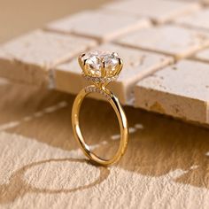 a diamond ring sitting on top of a table