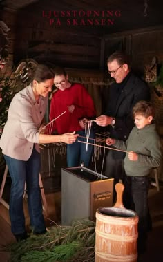 a woman and two children are looking at an object