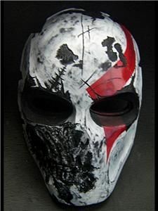 a white mask with red and black paint on it