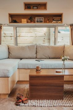 a living room with a couch, coffee table and window