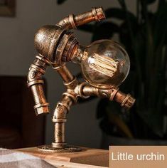 an antique looking lamp on top of a wooden table