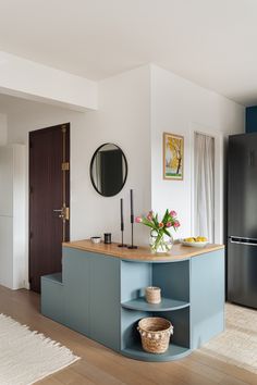 a kitchen with blue cabinets and wooden floors