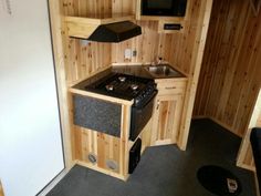 a kitchen with wood paneling and black appliances