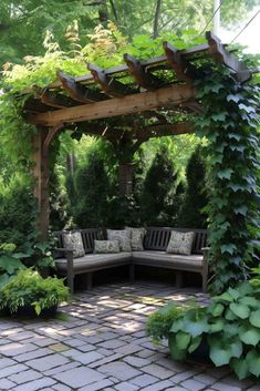 a wooden bench sitting under a pergoline covered arbor