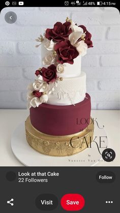 a three tiered wedding cake with red and white flowers