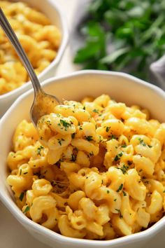 two white bowls filled with macaroni and cheese