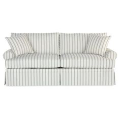 a white and blue striped couch with pillows