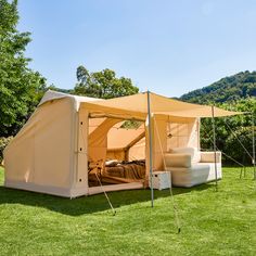 a tent set up in the middle of a field