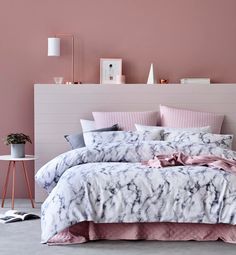 a bedroom with pink walls and marbled bedding in the foreground is an illustration of a woman's torso