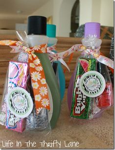 three candy bars wrapped in cellophane and tied with ribbons, sitting on a counter