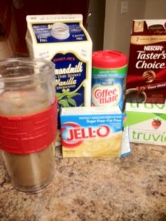 the ingredients for an iced coffee drink are sitting on the counter top next to milk, sugar, and other items