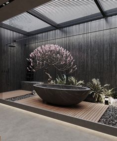 a large bowl shaped planter sitting on top of a wooden floor next to a wall