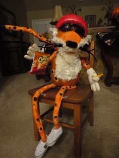 a stuffed animal sitting on top of a wooden chair