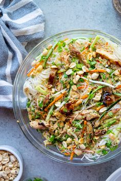 a glass bowl filled with vegetables and nuts