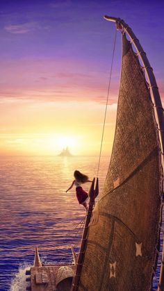 a woman standing on the side of a sailboat in the ocean at sunset or dawn