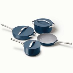 three pots and pans with lids on a white surface, one is blue and the other is silver