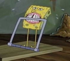 a spongebob standing on top of a piece of wood with its mouth open