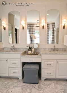 a large bathroom with two sinks and mirrors