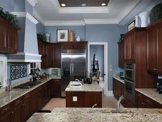 a kitchen with granite counter tops and wooden cabinets