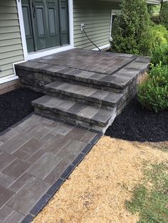 two steps leading up to the front door of a house