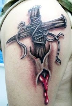 a cross tattoo on the back of a woman's shoulder with blood dripping from it