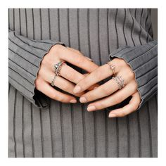 a woman's hands with three rings on them