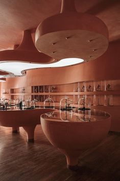 a room filled with lots of different types of vases and bowls on shelves next to each other