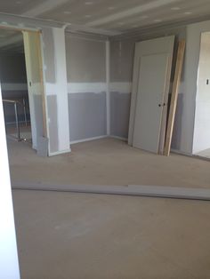 an empty room with unfinished walls and doors