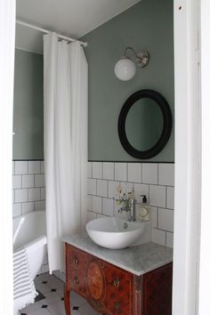 a white sink sitting under a mirror in a bathroom