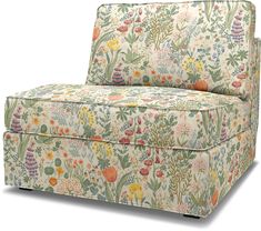 an upholstered couch with colorful flowers and plants on the back, against a white background