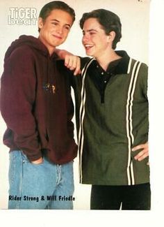 two young men standing next to each other in front of a white background with the words tiger box on it