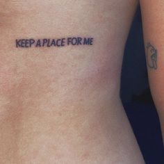 a woman's stomach with the words keep a place for me tattooed on it