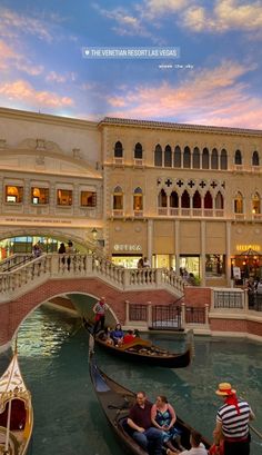 two gondolas in front of a building with people riding on one side and another going down the other