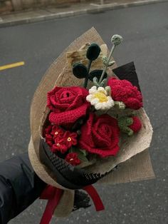 a person holding a bouquet of flowers on the street