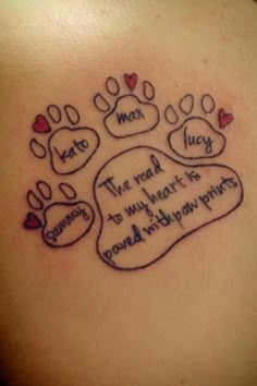 a tattoo with two paw prints on it and the words i love you in cursive