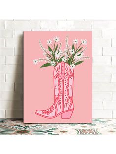 a pink poster with white flowers in a cowboy boot