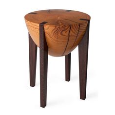 a wooden stool with an unusual design on it