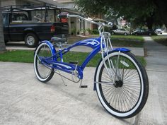 a blue and white bicycle parked on the sidewalk