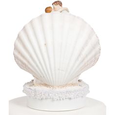 a white shell with a couple kissing on it