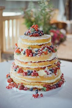 a triple layer cake with berries on top is featured in the instagram page for pinterest