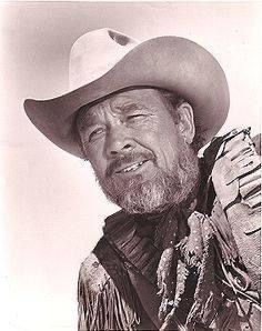 an old photo of a man wearing a cowboy hat