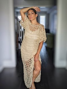 a woman in a crochet dress posing for the camera