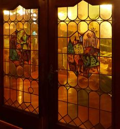 two stained glass doors with people on them