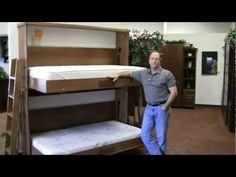 a man standing next to a bunk bed