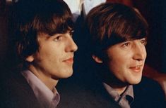 two young men sitting next to each other in front of a man wearing a suit