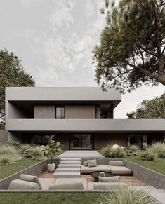 the modern house is surrounded by grass and trees